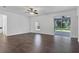 Bright living room with sleek floors, large windows, and a sliding glass door to the patio at 2038 Mincey Ter, North Port, FL 34286
