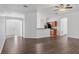 Open-concept living area features modern dark wood floors and connects to the kitchen at 2038 Mincey Ter, North Port, FL 34286
