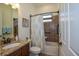 Bathroom featuring a granite countertop, tiled shower with curtain, and neutral color scheme at 20806 Valprato Ct, Venice, FL 34293