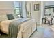 Guest bedroom features a bed, rocking chair and bright windows at 20806 Valprato Ct, Venice, FL 34293