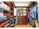 Custom closet with beautiful, wood-tone shelving and drawers at 20806 Valprato Ct, Venice, FL 34293