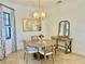 Cozy dining area featuring a round table, modern lighting, and tasteful decor, creating an inviting atmosphere at 20806 Valprato Ct, Venice, FL 34293