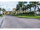 Entrance to the Gran Paradiso community featuring a brick road leading to the beautiful, arched gatehouse at 20806 Valprato Ct, Venice, FL 34293