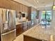 Modern kitchen with stainless steel appliances, granite countertops, ample cabinetry, and a functional design at 20806 Valprato Ct, Venice, FL 34293