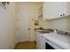 Bright laundry room featuring a modern washer and dryer, white cabinetry, and granite countertops at 20806 Valprato Ct, Venice, FL 34293