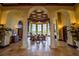 Elegant lobby with soaring ceilings, stone columns, and comfortable seating arrangements in a luxurious building at 20806 Valprato Ct, Venice, FL 34293