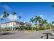 Main street features landscaped sidewalks and palm trees along a street with shops and restaurants at 20806 Valprato Ct, Venice, FL 34293