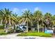 Beautiful Venice Beach entrance with lush landscaping and majestic palm trees at 20806 Valprato Ct, Venice, FL 34293