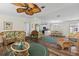 Inviting living room open to the kitchen and dining areas featuring stylish furnishings and wood-look flooring at 222 Como Dr, Venice, FL 34285