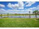 Lush backyard with green grass and serene water view at 229 Brindisi Cir, Nokomis, FL 34275