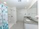 Bright bathroom featuring double sinks, granite counters, and a walk-in shower at 2450 Sahara Ln, North Port, FL 34286
