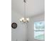 Bright dining area features a stylish chandelier and natural light from the window at 2450 Sahara Ln, North Port, FL 34286