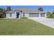 Charming single-Gathering home featuring a three-car garage and well-maintained lawn at 2450 Sahara Ln, North Port, FL 34286
