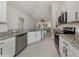 Modern kitchen with stainless steel appliances, granite counters, and white cabinetry at 2450 Sahara Ln, North Port, FL 34286