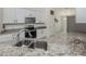 Updated kitchen with granite countertops, stainless steel appliances and white cabinetry at 2450 Sahara Ln, North Port, FL 34286