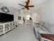 Spacious living room with neutral tile flooring leading into an open concept kitchen at 2450 Sahara Ln, North Port, FL 34286