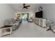 Bright living area featuring tile flooring, large fan, and sliding glass doors to a screened lanai at 2450 Sahara Ln, North Port, FL 34286