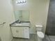 Modern bathroom with a granite vanity, stylish mirror, and tiled shower at 2643 Orchard Cir, North Port, FL 34288