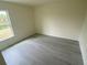 Clean bedroom with a window and hardwood-style flooring at 2643 Orchard Cir, North Port, FL 34288