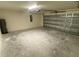 Large two-car garage with a concrete floor at 2643 Orchard Cir, North Port, FL 34288