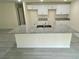 Close-up of kitchen island with granite countertop, undermount sink and tile floors at 2643 Orchard Cir, North Port, FL 34288