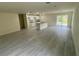 Spacious living room featuring tile floors, recessed lighting, and sliding door access to the backyard at 2643 Orchard Cir, North Port, FL 34288