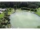 The pond area has many lounge chairs and umbrellas at 2694 Hopwood Rd, North Port, FL 34287