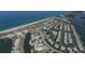 An aerial view of a coastal community with a beautiful beach, a harbor, and rows of charming homes at 2694 Hopwood Rd, North Port, FL 34287