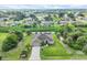 Expansive aerial view showcases the home's position in a peaceful community with mature trees and green spaces at 2694 Hopwood Rd, North Port, FL 34287