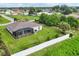 Aerial view of a home with a screened-in lanai and well-manicured backyard at 2694 Hopwood Rd, North Port, FL 34287