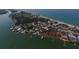 An aerial view capturing a picturesque coastal neighborhood with waterfront homes, a marina, and lush greenery at 2694 Hopwood Rd, North Port, FL 34287