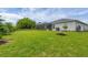 Expansive backyard with lush green grass, featuring an enclosed lanai, and well-maintained landscaping at 2694 Hopwood Rd, North Port, FL 34287