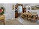 Charming dining room has a traditional table and cabinet, plus a decorative window at 2694 Hopwood Rd, North Port, FL 34287