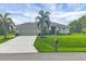 Inviting single-Gathering home with an attached garage, well-kept lawn, and a neatly landscaped front yard at 2694 Hopwood Rd, North Port, FL 34287