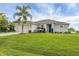 Attractive one story home featuring an attached garage, well kept lawn, and lush landscaping at 2694 Hopwood Rd, North Port, FL 34287