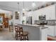 Open kitchen features a breakfast bar, white cabinets, and pendant lighting at 2694 Hopwood Rd, North Port, FL 34287