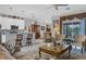 Open concept living room features a kitchen bar, stylish furniture, and water views at 2694 Hopwood Rd, North Port, FL 34287