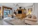 Inviting living room with ceiling fan, view of water, and large entertainment center at 2694 Hopwood Rd, North Port, FL 34287