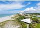 Stunning aerial shot of a beachfront community with a pavilion, white sand, and clear blue water at 325 Fiesole St, Venice, FL 34285