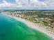 Scenic aerial shot of a beachfront community featuring white sand, turquoise water, and the neighborhood at 325 Fiesole St, Venice, FL 34285