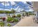 Screened-in patio with landscaped yard featuring a stone garden and outdoor furniture at 325 Fiesole St, Venice, FL 34285