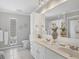 Well-lit bathroom with double sinks, large mirror, and modern fixtures at 325 Fiesole St, Venice, FL 34285