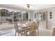 Bright dining area with table, chairs and screened lanai view at 325 Fiesole St, Venice, FL 34285