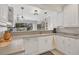 Well-lit kitchen featuring white cabinets and ample counter space at 325 Fiesole St, Venice, FL 34285