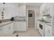 Bright kitchen equipped with white cabinets and modern appliances at 325 Fiesole St, Venice, FL 34285