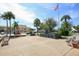 Outdoor memorial space with palm trees, tropical foliage, and nearby buildings at 325 Fiesole St, Venice, FL 34285
