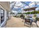 Enclosed patio with an outdoor dining area and views of the manicured backyard at 325 Fiesole St, Venice, FL 34285