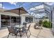 Enclosed patio featuring an outdoor dining set and comfortable lounge chairs at 325 Fiesole St, Venice, FL 34285