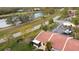 A bird's eye view of a townhome community nestled by a serene lake and lush green surroundings at 3641 Longmeadow # 33, Sarasota, FL 34235
