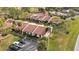 A stunning aerial view of townhomes featuring well-maintained landscaping and ample parking space at 3641 Longmeadow # 33, Sarasota, FL 34235